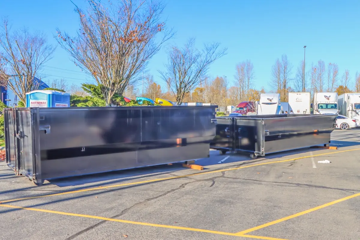 Professional dumpster rental service with roll-off container on residential driveway in Drexel Heights